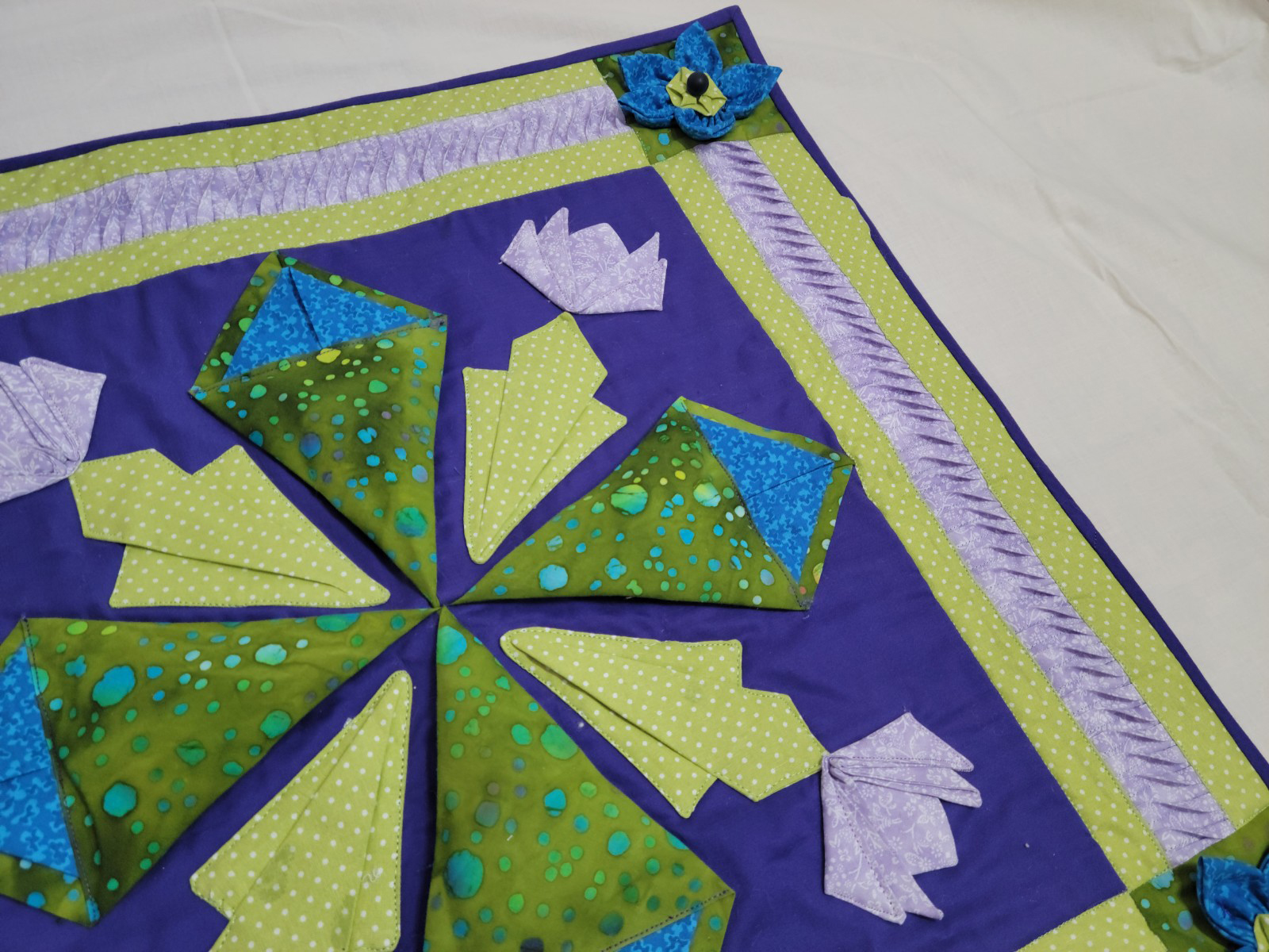 Flip and Fiddle Fabrication Manipulation example, green and purple flowers close up view